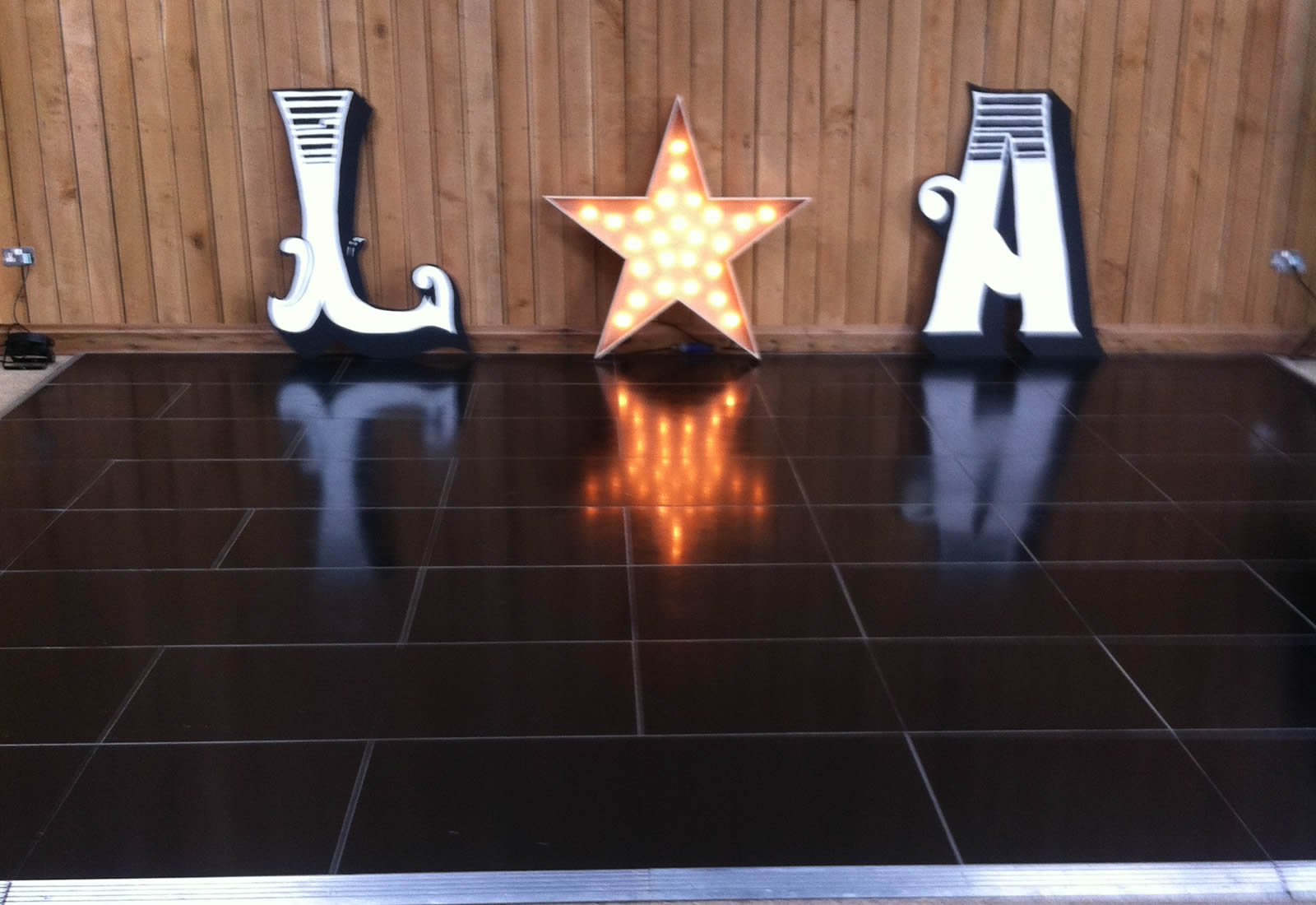 Black dance floor with letters and light up star